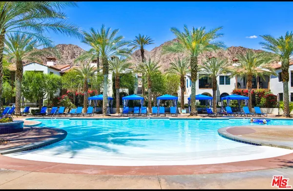 a front view of a house with glass windows and furniture