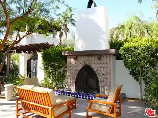 front view of a house with a yard and potted plants