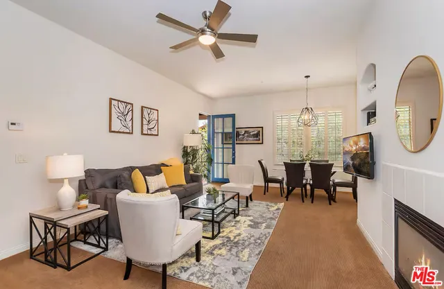 a living room with furniture a rug and a fireplace