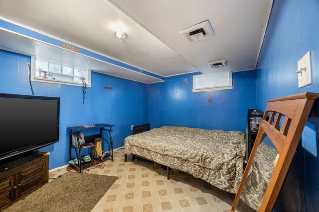 a bedroom with furniture and a flat screen tv