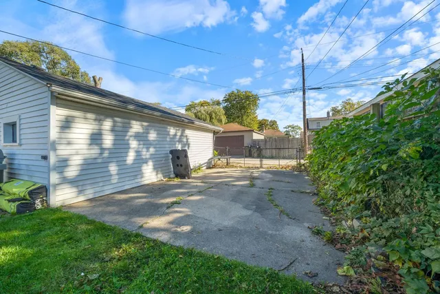 a view of a backyard with plants and a garden
