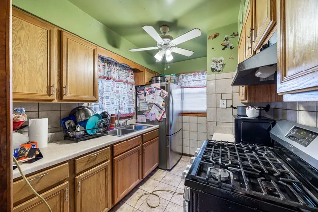 a kitchen with stainless steel appliances granite countertop a stove and a sink