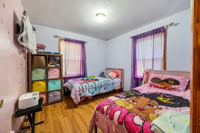 a bedroom with two beds and a window