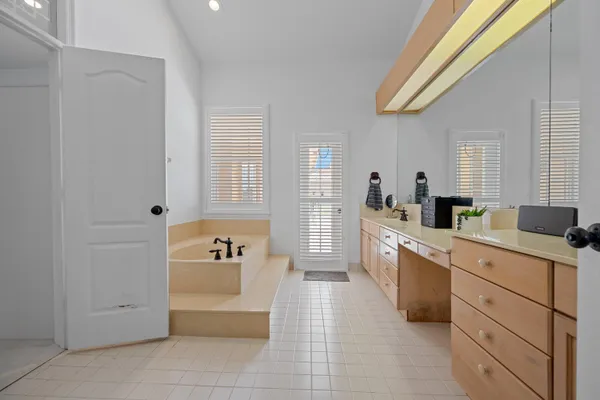 a large white kitchen with granite countertop a sink