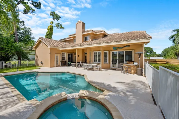 a swimming pool with outdoor seating yard and barbeque oven