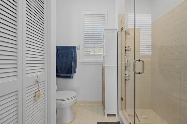 a bathroom with a toilet and a shower