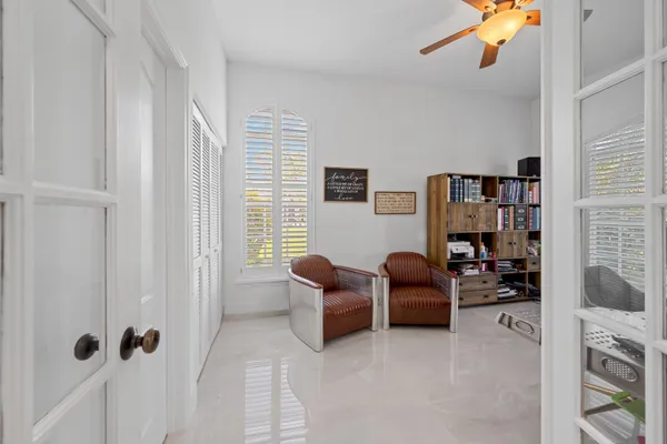 a living room with furniture cabinets and a window
