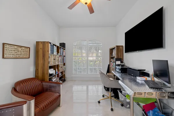 a livingroom with workspace and a couch
