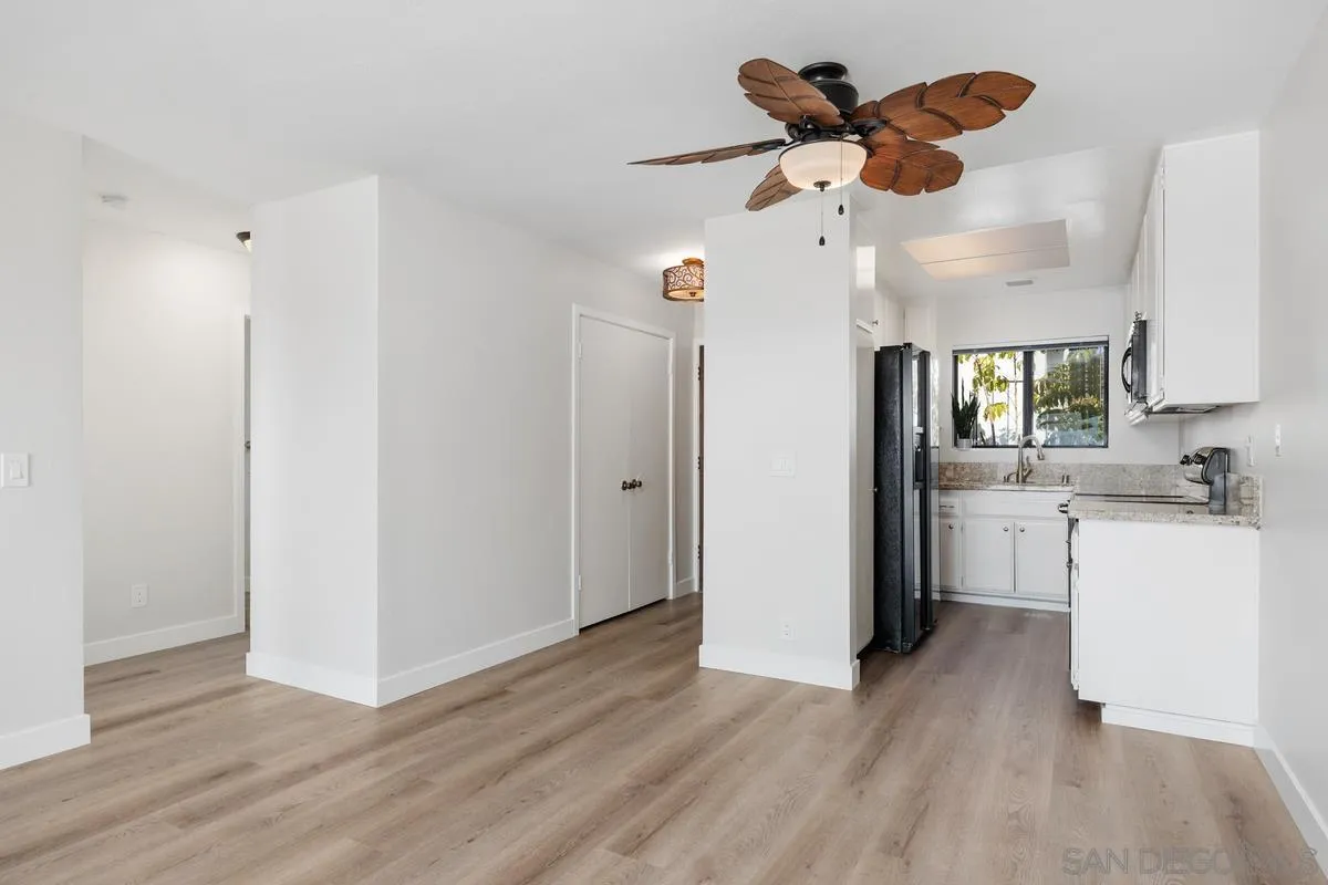 245 Fairlee Lane Encinitas, CA 92024 - Photo 3 of 18 a view of an empty room and kitchen with wooden floor
