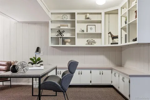 a view of a kitchen with furniture and wooden floor