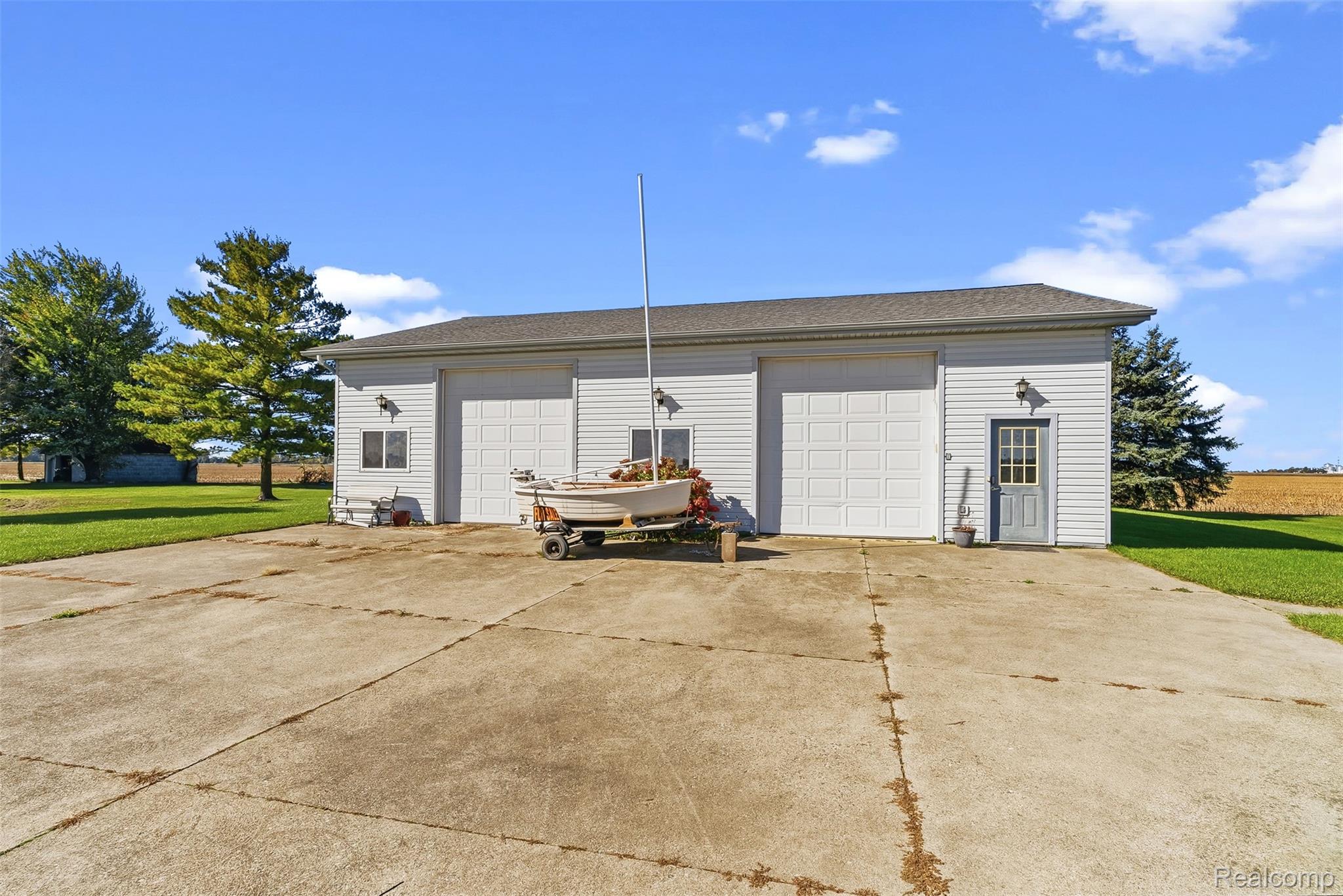 2227 North Graf Road Caro, MI 48723 - Photo 48 of 51 Detached garage with two white overhead doors and a separate entry door
