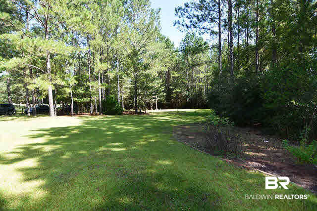 13848 Elmwood Court Stapleton, AL 36578 - Photo 18 of 27 Tranquil and green! Breath the fresh air from your front porch or take a walk on the many trails surrounding your home. 3.5 acres of paradise. All fenced.