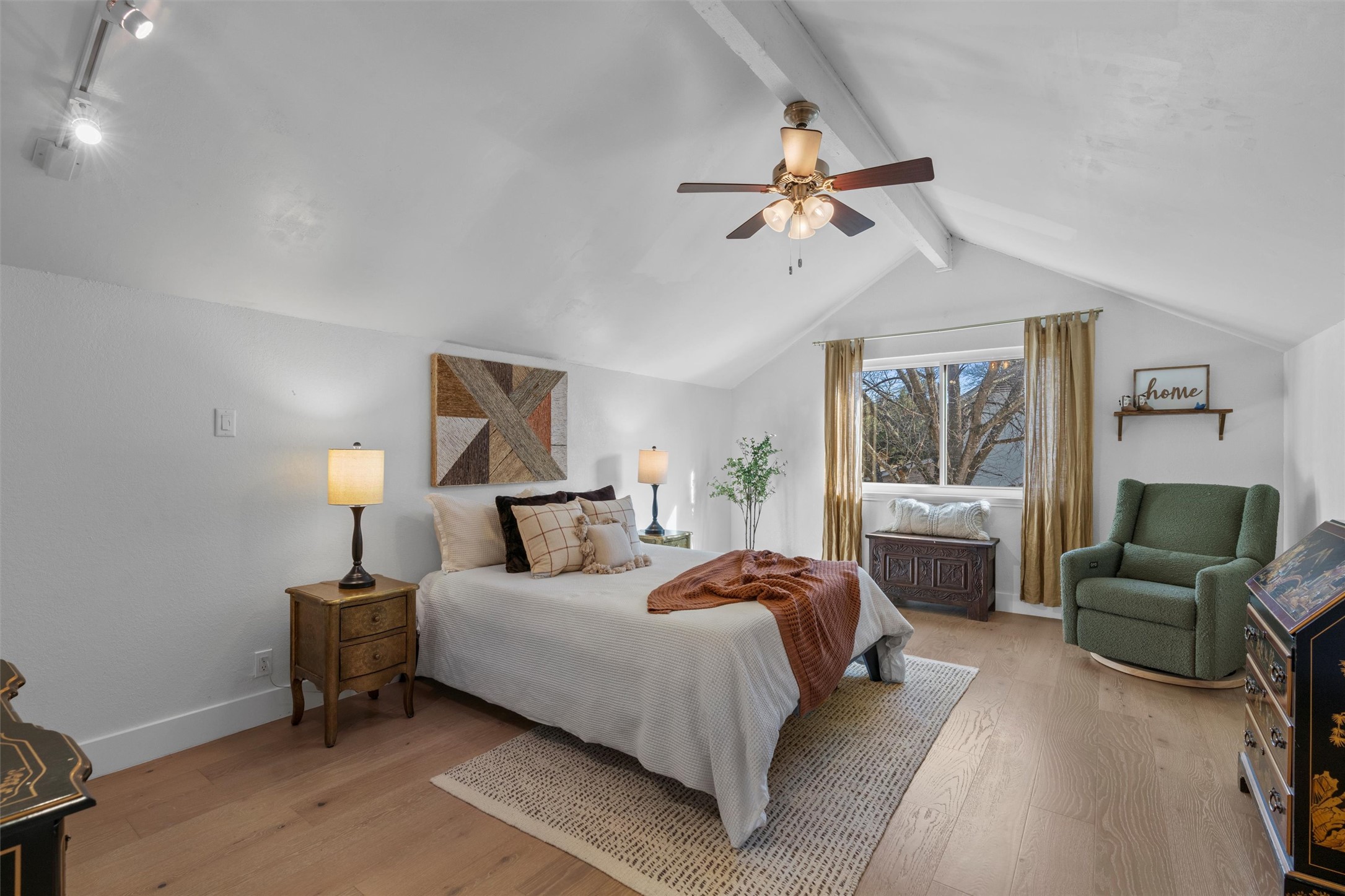 3431 Bliss Spillar Road Manchaca, TX 78652 - Photo 12 of 30 Bedroom featuring light wood finished floors, ceiling fan, rail lighting, and beam ceiling