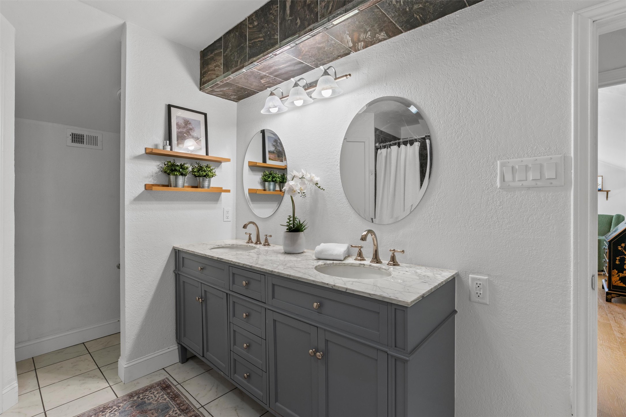 3431 Bliss Spillar Road Manchaca, TX 78652 - Photo 14 of 30 Bathroom featuring double vanity, a textured wall, and curtained shower