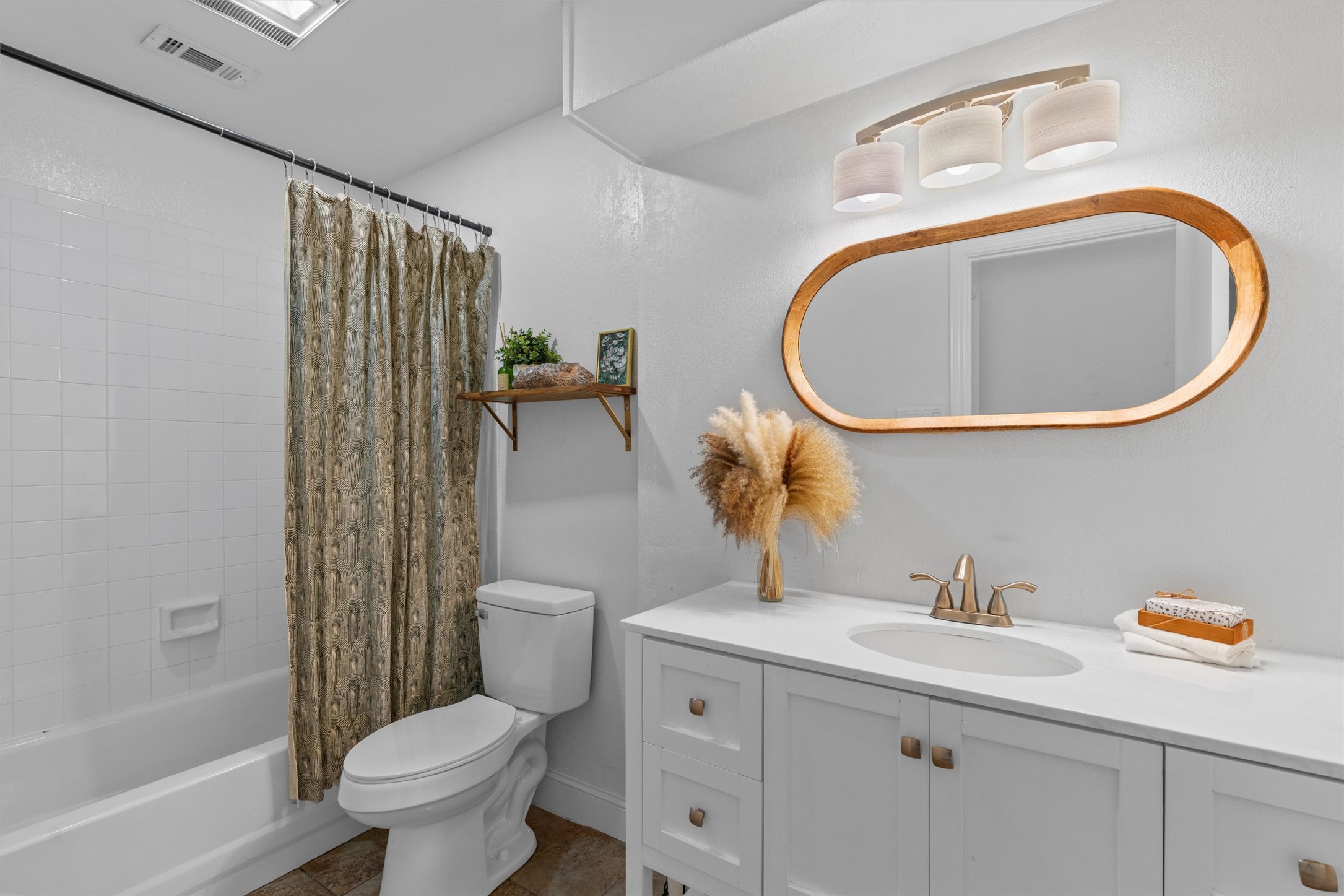 3431 Bliss Spillar Road Manchaca, TX 78652 - Photo 21 of 30 Full bathroom with vanity, shower / bathtub combination with curtain, and dark tile patterned flooring