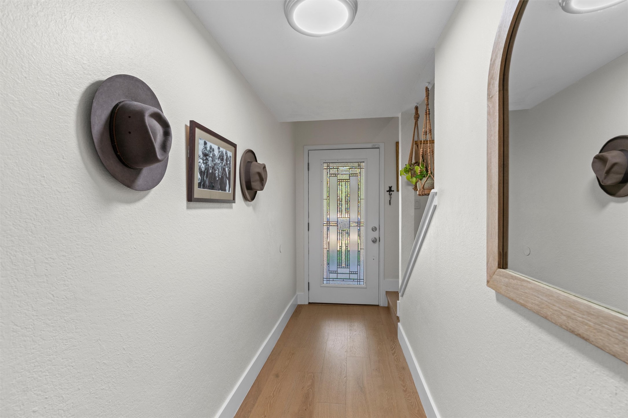 3431 Bliss Spillar Road Manchaca, TX 78652 - Photo 4 of 30 Doorway to outside featuring wood finished floors and a textured wall