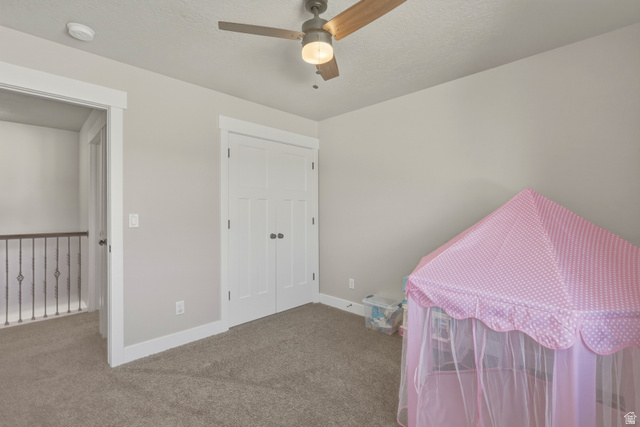 836 South 250 West Vernal, UT 84078 - Photo 35 of 56 Bedroom with carpet floors, a closet, a ceiling fan, and a textured ceiling