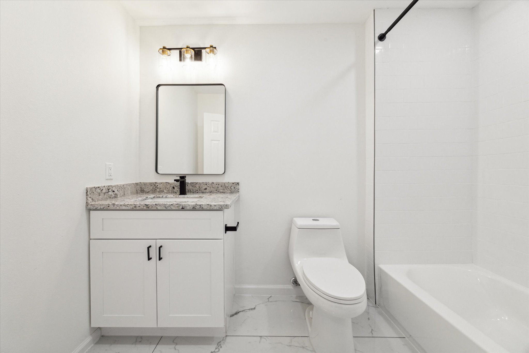 9911 Porto Rico Road, Unit A Houston, TX 77041 - Photo 13 of 15 a bathroom with a toilet sink and mirror