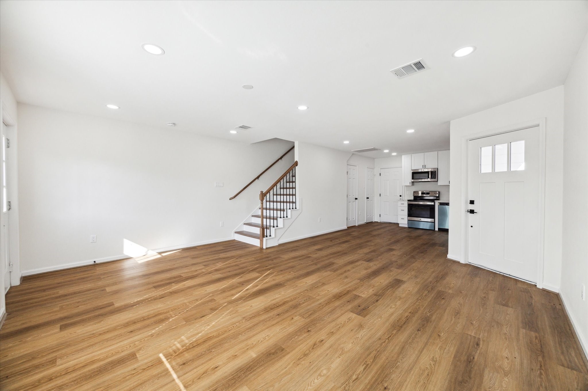 9911 Porto Rico Road, Unit A Houston, TX 77041 - Photo 3 of 15 a view of empty room with wooden floor and window