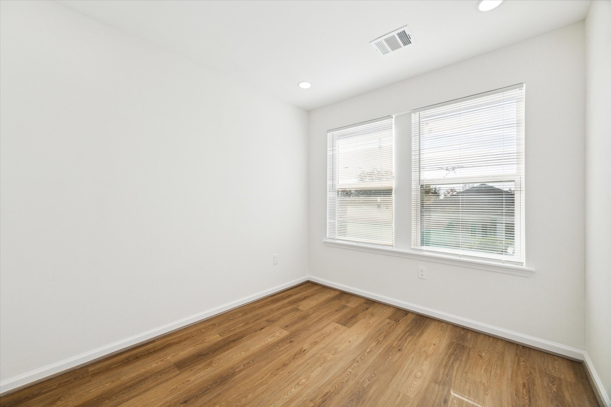 9911 Porto Rico Road, Unit A Houston, TX 77041 - Photo 10 of 15 an empty room with wooden floor and windows