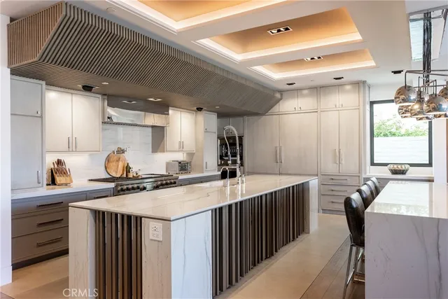 a kitchen with a sink appliances cabinets and furniture