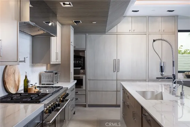 a kitchen with granite countertop a sink stove and cabinets