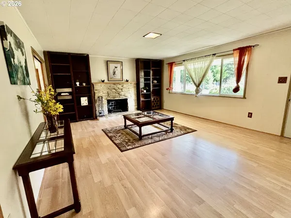 a living room with furniture flat screen tv and a large window