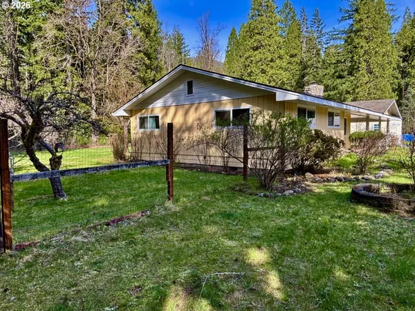 a front view of a house with garden yard and deck