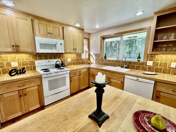 a kitchen with a sink appliances cabinets and a counter top space