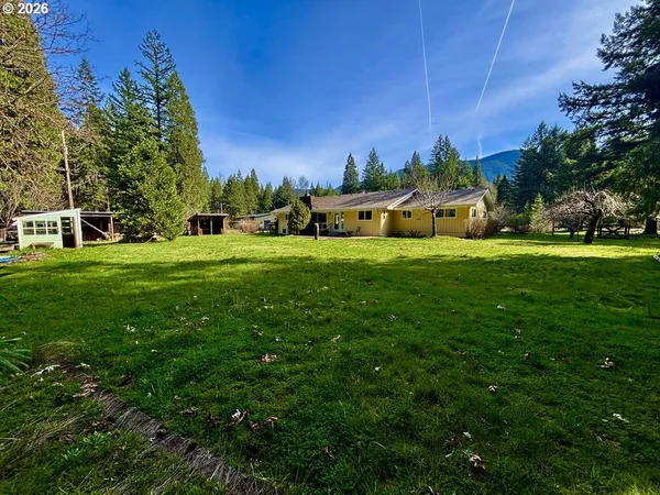 a front view of a house with swimming pool and a yard