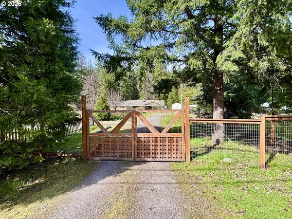 a front view of a house with a yard and trees