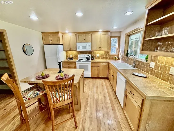 a large kitchen with a table and chairs in it