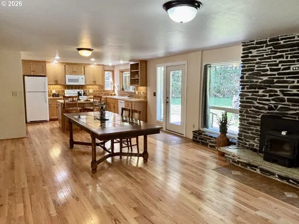 a dining room with furniture and wooden floor