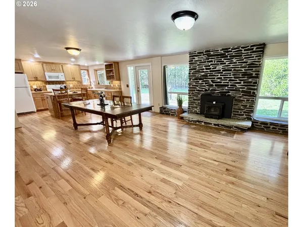 a living room with furniture a fireplace and wooden floor