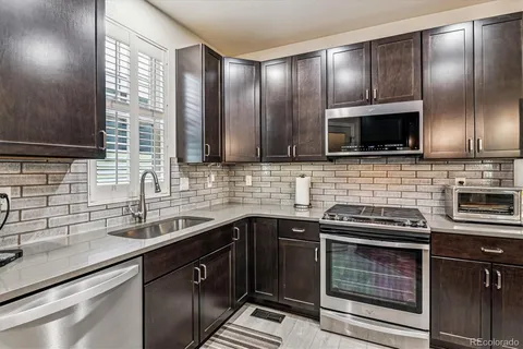 a kitchen with a sink stove and microwave