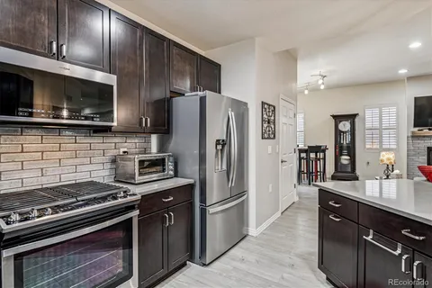 a kitchen with stainless steel appliances and wooden cabinets