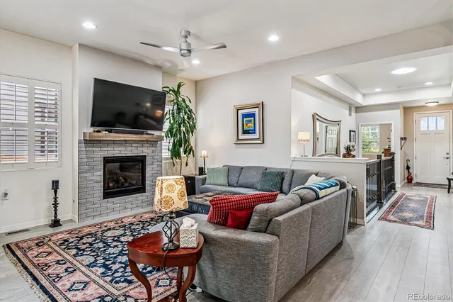 a living room with furniture a flat screen tv and a fireplace