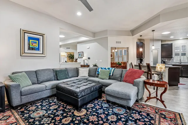 a living room with furniture and view of kitchen