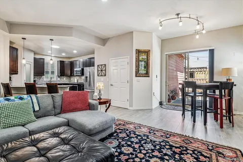 a living room with furniture and wooden floor