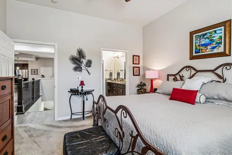 a bedroom with furniture and a mirror