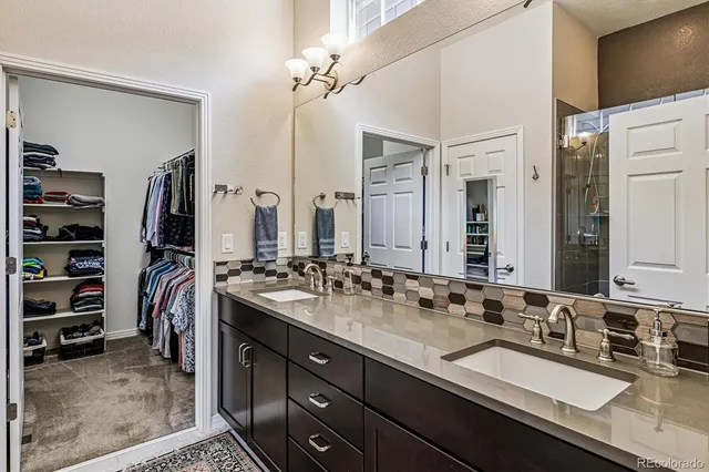 a bathroom with a double vanity sink and a mirror
