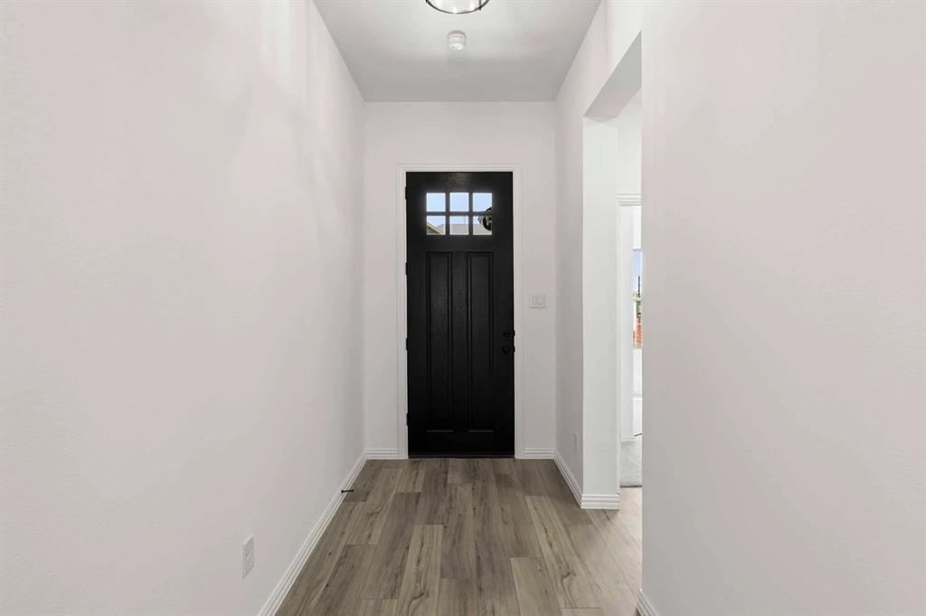 1909 Wishon Road Celina, TX 75009 - Photo 14 of 40 a view of an empty room with wooden floor and closet
