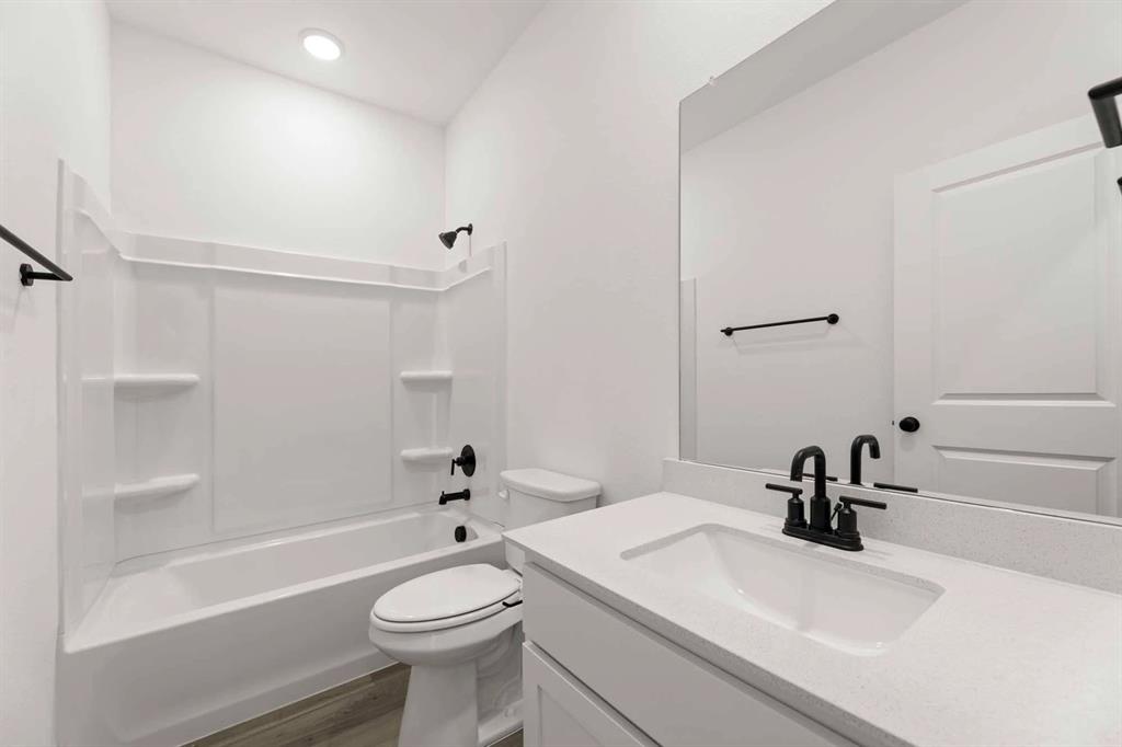 1909 Wishon Road Celina, TX 75009 - Photo 18 of 40 a bathroom with a sink a toilet and a mirror