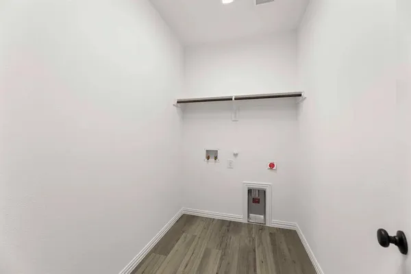 a view of a room with wooden floor