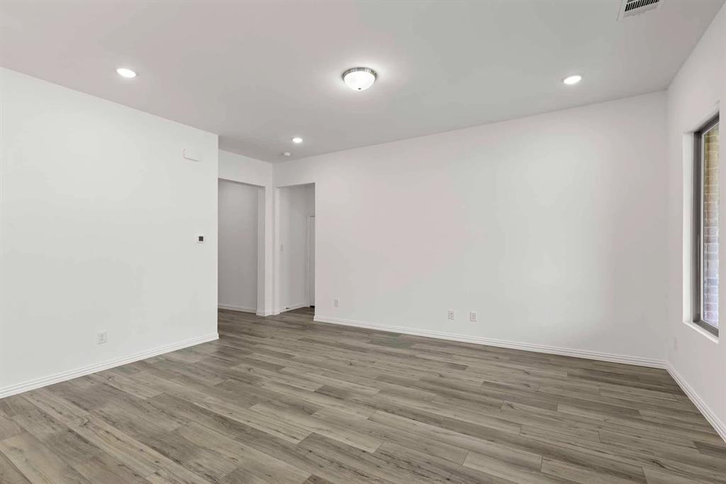 1909 Wishon Road Celina, TX 75009 - Photo 25 of 40 a view of an empty room with wooden floor