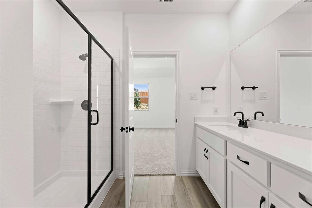 1909 Wishon Road Celina, TX 75009 - Photo 36 of 40 a bathroom with a sink a toilet a mirror and shower