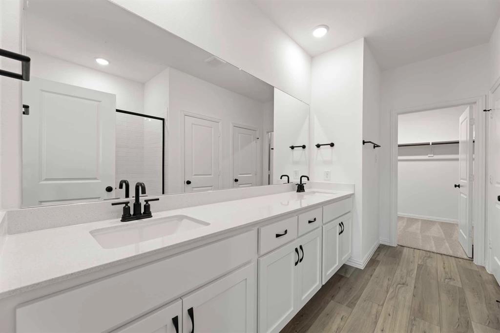 1909 Wishon Road Celina, TX 75009 - Photo 37 of 40 a bathroom with a double vanity sink and mirror