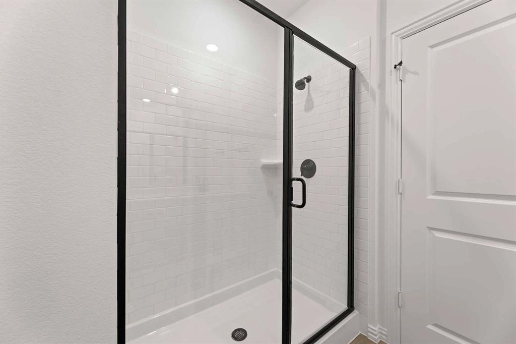 1909 Wishon Road Celina, TX 75009 - Photo 38 of 40 a bathroom with a shower and a glass door