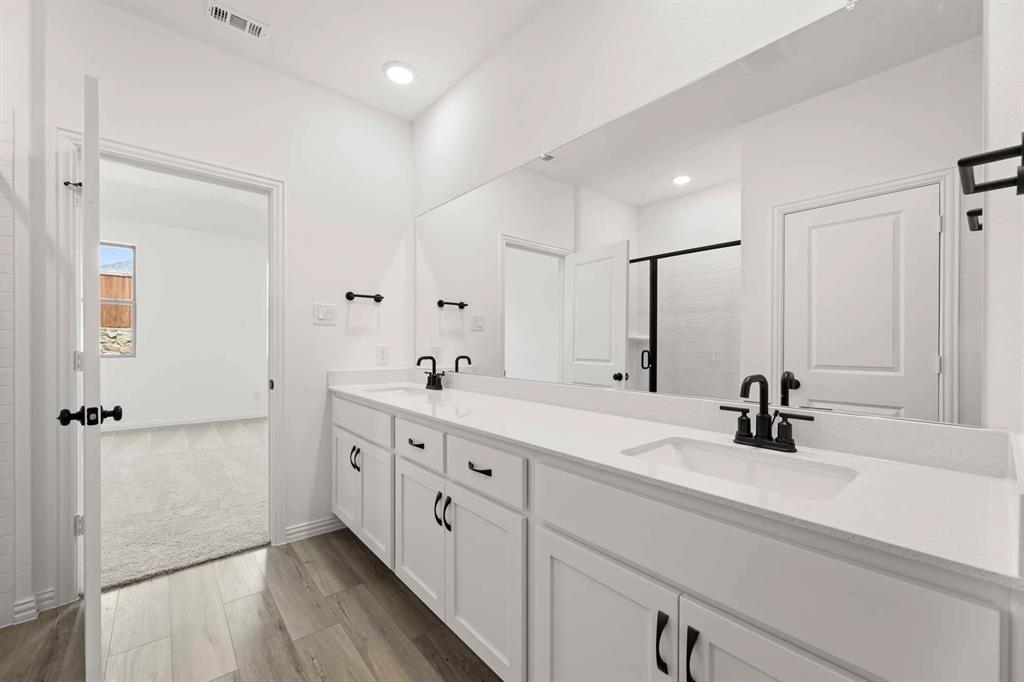1909 Wishon Road Celina, TX 75009 - Photo 39 of 40 a bathroom with double vanity sink a mirror and shower