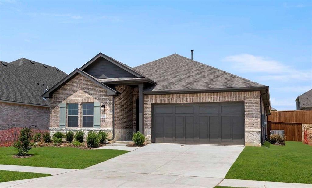 1909 Wishon Road Celina, TX 75009 - Photo 8 of 40 a front view of a house with a garden and garage